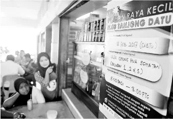  ??  ?? Members of the public looking at a notice for the Tanjong Datu by-election placed at a food stall in Sematan yesterday. Voters will head to the polls on Saturday. – Bernama photo
