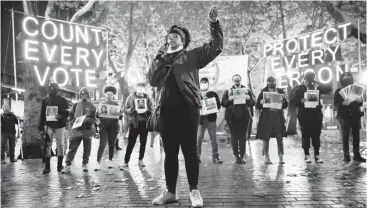  ?? ERIKA SCHULTZ/THE SEATTLETIM­ES ?? Travonna Thompson-Wiley, of the Black Action Coalition, speaks last month during a rally and march at Occidental Park in Seattle. Among other things, the coalition demands the Electoral College be eliminated.