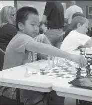  ??  ?? Chilong Vang, a student at Lincoln Middle School, plays a chess match during 2016. The school’s chess team brought home first place from a national chess tournament.