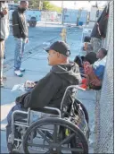  ??  ?? Clients, including Nicholas Lerma, 29, gather outside the Courtyard Homeless Resource Center on Wednesday.