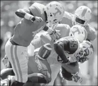  ??  ?? Tennessee linebacker Dontavis Sapp (left) strips the ball from Western Kentucky running back Keshawn Simpson during Saturday’s game in Knoxville, Tenn.