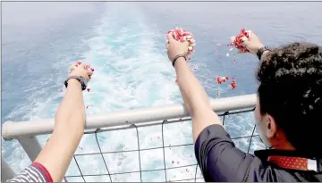  ??  ?? File photo shows families and colleagues of passengers and crew of Lion Air flight JT610 throw flowers and petals from the deck of Indonesia Navy ship KRI Banjarmasi­n as they visit the site of the crash to pay their tribute, at the north coast of Karawang. — Reuters photo