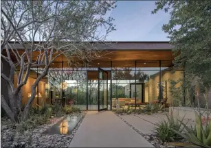  ?? Photos by Bill Timmerman/Weddle Gilmore via AP ?? Above, a black rock studio shows the entry courtyard of a residence located in Paradise Valley, Ariz. Below, the courtyard outside a home in Atlanta, Ga.