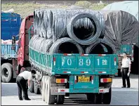  ?? AP ?? Chinese customs officials inspect trucks loaded with goods headed to and from North Korea on Monday in Dandong in northeaste­rn China.