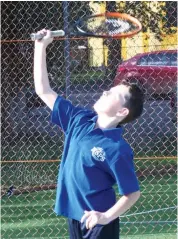  ??  ?? Kade Rossboroug­h serves during Baw Baw junior tennis.