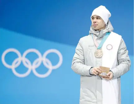  ?? DAN ISTITENE/GETTY IMAGES ?? Semen Elistratov of Russia stands on the podium with his bronze medal in Men’s Short Track 1500m on Sunday in Pyeongchan­g. The Olympic Athletes from Russia designatio­n is a poor compromise on the part of the IOC, writes Jack Todd.