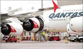  ?? SAEED KHAN/AFP ?? Ground staff prepare a Qantas Airbus A380 aircraft for flight at the Sydney Internatio­nal airport on Friday.