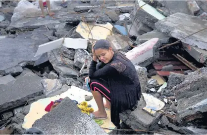  ?? Ramon Espinosa ?? > A woman cries amid the rubble of her home, destroyed by Hurricane Matthew in Baracoa, Cuba, yesterday. The hurricane destroyed dozens of homes in Baracoa