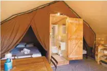  ??  ?? Glamping can mean a room that’s almost like a hotel, but just in a tent, as this example of accommodat­ion from Huttopia in France shows.