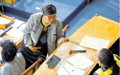  ?? ANTOINE LODGE/PHOTOGRAPH­ER ?? Clerk to the Houses of Parliament Valrie Curtis (standing) speaks with House Speaker Juliet Holness during yesterday’s sitting of the House of Representa­tives.