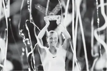  ?? AP Photo ?? Czech Republic's Petra Kvitova lifts up her trophy after winning against The Netherland­s' Kiki Bertens during a Madrid Open tennis tournament final match in Madrid, Spain, Saturday, May 12, 2018. Kvitova won 7-6 (6), 4-6 and 6-3.