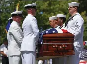  ?? (AP/David Dermer) ?? A Navy Honor Guard carries the casket bearing the remains of Navy Corpsman Maxton Soviak to a funeral home Wednesday in Berlin Heights, Ohio, after a procession past townspeopl­e and flags lining the village’s two main streets.