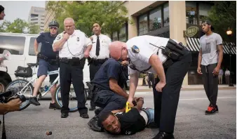  ?? Getty ?? Activist Kwame Rose, who features in ‘Baltimore Rising’, is arrested during protests in the city