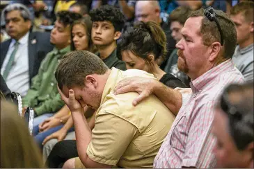  ?? PHOTOS BY JAY JANNER / AMERICAN-STATESMAN ?? Santa Fe High student Aaron Chenowith is comforted by his father, Richard Chenowith, during a roundtable Thursday. Sessions included students from schools struck by gun violence.