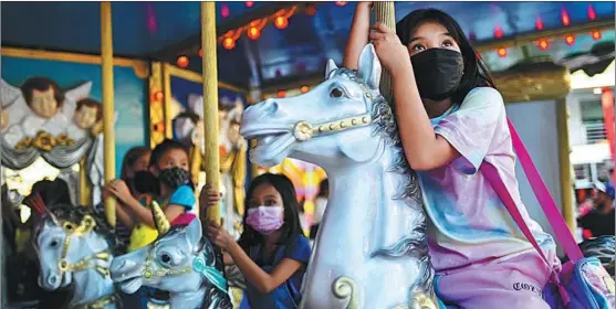  ?? LISA MARIE DAVID / REUTERS ?? COVID-19 safety protocols accompany the reopening of an amusement park in the Metro Manila area of the Philippine­s on Feb 24.