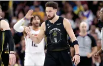  ?? Ezra Shaw / Getty Images ?? Klaythomps­on (11) of the Golden State Warriors reacts after making a basket and being fouled in the second half against the Phoenix Suns at Chase Center on Monday.