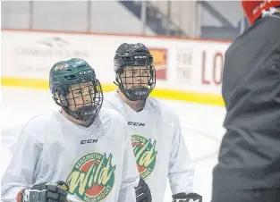  ?? FILE ?? Kensington Monaghan Farms Wild forwards Landon Clow, left, and Reid Vos listen to head coach Kyle Dunn during a practice earlier this season.