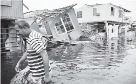  ?? AFP ?? Un hombre camina por una calle inundada, en Juana Matos, Puerto Rico .