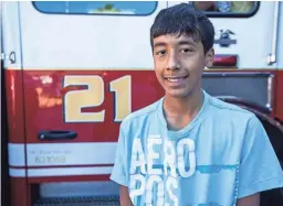  ?? SEAN LOGAN/THE REPUBLIC ?? Eric Mendez, 14, stands for a photo Wednesday in front of Phoenix Engine No. 21.