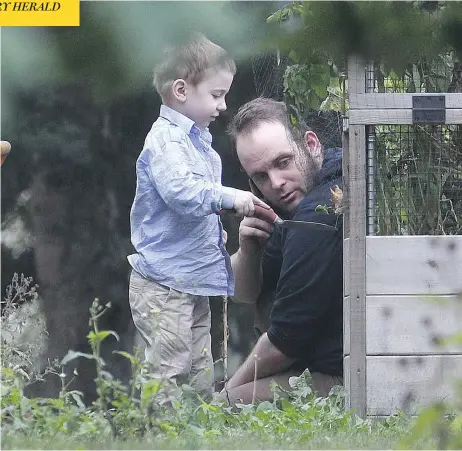  ?? LARS HAGBERG / THE CANADIAN PRESS ?? Joshua Boyle and his son Jonah play in the garden at his parents’ house in Smiths Falls, Ont., on Saturday. Jonah was born in Afghanista­n.