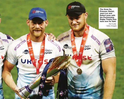  ?? PICTURE: Getty Images ?? The three Du Preezes: Daniel, Jean-Luc and Robert pose with the Premiershi­p Rugby Trophy they have won for Sale