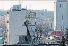  ?? THE ASSOCIATED PRESS ?? Rescuers work at a collapsed building in Poznan, Poland, Sunday. Forty people lived in the 18 apartments.