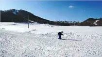  ??  ?? a Chinese skier enjoys the easy route back to the ski lifts at the bottom of the slopes.