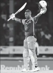  ??  ?? Jamaica Tallawahs captain Andre Russell celebrates his hundred against TKR in the third match of the Caribbean Premier League at Queen’s Park Oval on Friday night. (Photo courtesy CPL)