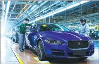  ??  ?? Final adjustment­s of cars are made at a Jaguar XEL production line.