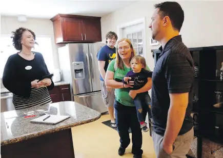  ?? PHOTOS BY TRIBUNE NEWS SERVICE ?? Real-estate agent Brandy Reading, left, talks with homeowner Matt Furman, right, as Reading gives a tour to a family interested in buying the three-bedroom, two-bathroom home in San Jose during an open house. The Furmans listed the property at $725,000...
