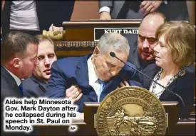  ?? AP ?? Aides help Minnesota Gov. Mark Dayton after he collapsed during his speech in St. Paul on Monday.