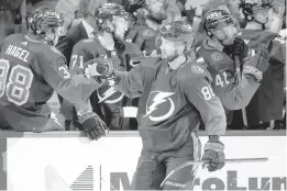  ?? CHRIS O’MEARA/AP ?? Tampa Bay Lightning right wing Nikita Kucherov (86) celebrates with the bench after scoring against the Winnipeg Jets during the third period on Saturday night.