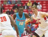  ?? CHRIS CALDWELL/FOR THE JOURNAL ?? New Mexico’s Makuach Maluach drives between defenders during the Lobos’ 72-63 win over Dixie State Wednesday in St. George, Utah.