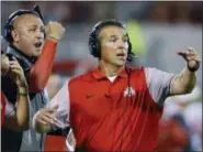  ?? SUE OGROCKI — THE ASSOCIATED PRESS ?? In this Sept. 17, 2016, file photo, Ohio State head coach Urban Meyer, right, and then-assistant coach Zach Smith, left, gesture from the sidelines during an NCAA college football game against Oklahoma in Norman, Okla.
