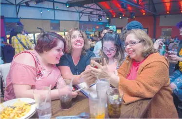  ?? EDDIE MOORE/JOURNAL ?? From left, Isabella Mendoza, Amber Espinosa-Trujillo, Gabriella Mendoza and Mary Ann Soto watch the results of the sugary drinks tax come in Tuesday at the Boxcar Bar and Grill, where opponents of the tax gathered. Espinosa-Trujillo is the wife of City...