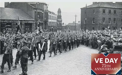  ??  ?? PARADE: Crowds watch The Dukes marching into Bull Green, Halifax, after the Freedom of the Borough ceremony in June 1945