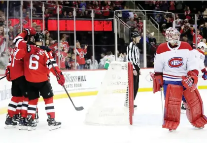  ?? JULIO CORTEZ/THE ASSOCIATED PRESS ?? Devils players celebrate one of their fives goals against Carey Price Wednesday night in Newark, N.J. In October, the Canadiens allowed the sixth-fewest goals against, but in November, the team has surrendere­d the second-most goals against, Marc Dumont writes.