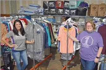  ?? TAMMY KEITH/CONTRIBUTI­NG PHOTOGRAPH­ER ?? Lacey Outlaw, left, community programs advocate II for the Community Action Program for Central Arkansas, and Melissa Allen, community programs director for CAPCA, stand in the warehouse with free clothing and items that are offered daily. After the annual Project Homeless Connect was canceled because of COVID-19, the staff started street-outreach days to provide supplies, free services and a hot meal. The next event will be from 10 a.m. to 2 p.m. Friday in the parking lot of the CAPCA office, 707 Robins St., Suite 700, in Conway.