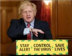  ?? Pippa Fowles/10 Downing Street/AFP via Getty Images ?? British Prime Minister Boris Johnson attends a remote news conference to update the nation on the COVID-19 pandemic Wednesday inside No. 10 Downing Street in central London.