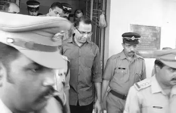  ??  ?? File photo shows Indian police officials escort Vadakkumch­ery (centre) after his arrest in Peravoor. — AFP photo