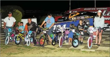  ?? SUBMITTED PHOTO - RICH KEPNER ?? Kory Fleming and the Sleepy Hollow race team bike giveaway recipients stand in victory lane on July 2at Grandview.