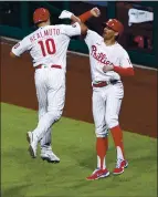  ?? DERIK HAMILTON — THE ASSOCIATED PRESS ?? The Phillies’ J.T. Realmuto (10) is congratula­ted by Brad Miller after he hit a two-run homer off the Milwaukee Brewers’ Adrian Houser.