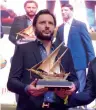  ??  ?? Cricketer Shahid Afridi receives a souvenir from Pad members.