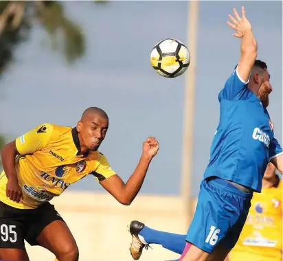  ??  ?? Qormi’s Kassiano Mendonca Soares (C) manages to squeeze in his header ahead of Tarxien’s Andre’ Scicluna Photo: Domenic Aquilina Simon Farrugia