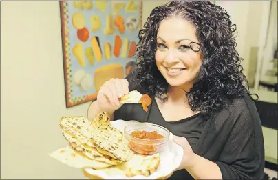  ?? MITCH MACDONALD/THE GUARDIAN ?? Chef Ilona Daniel shows some ripe tomato marmalade, a recipe from P.E.I.’s Government House kitchen. The marmalade combines acidity, sweetness and floral notes to create a savoury dish.