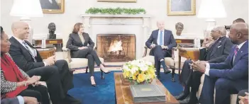  ?? — AFP photo ?? Biden (right) and US vice-president Kamala Harris meet with members of the Congressio­nal Black Caucus in the Oval Office of the White House in Washington, DC.