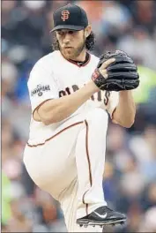  ?? Ben Margot Associated Press ?? MADISON BUMGARNER of the Giants holds the Dodgers scoreless into the seventh inning.