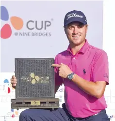  ??  ?? Justin Thomas of the US poses with the trophy at the awards ceremony after winning the CJ Cup at Nine Bridges in Jeju Island. - AFP photo