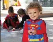  ??  ?? Blake Didget, 1, sports a Superman costume while at the Mosaic community garden crafts station during the Haunts on High event in Pottstown on Saturday.