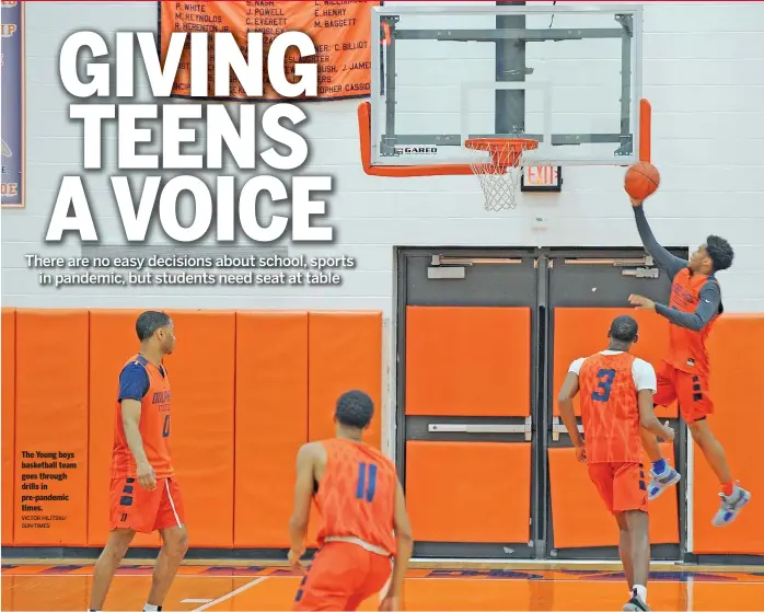  ?? VICTOR HILITSKI/ SUN-TIMES ?? The Young boys basketball team goes through drills in pre-pandemic times.